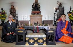 <p>　弁財天（中央上）の両脇に２体ずつ安置された白色の仏像と、高校生仏師の大久保汰佳さん（左）。右は園城寺住職の福家俊彦氏＝２１日、大津市</p>
