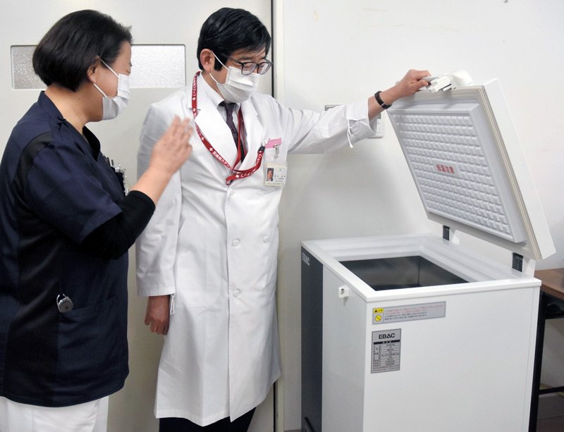 新型コロナウイルス感染症ワクチンを保管するため超低温冷凍庫が設置され、岡本美孝院長（右）らが確認した＝５日午後、市原市の千葉ろうさい病院