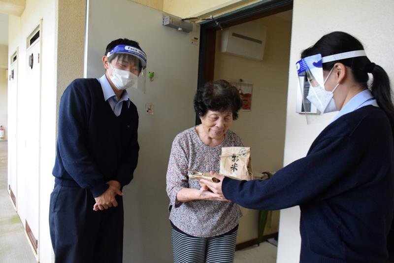 学校の田んぼで実った米を入居者に渡す生徒＝旭市