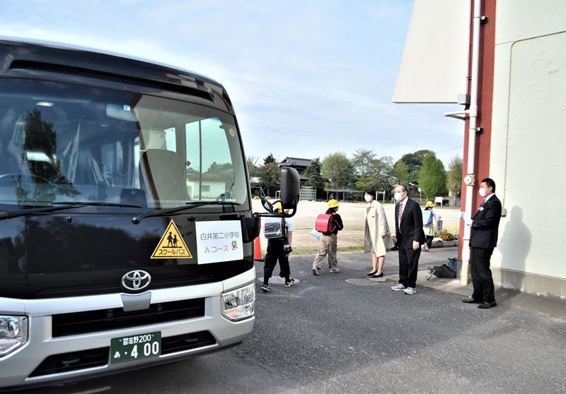 白井市と同市教委が登下校安全対策で導入を決め、今月から運行が始まったスクールバスで到着した児童たち＝１８日朝、白井市中の白井第二小
