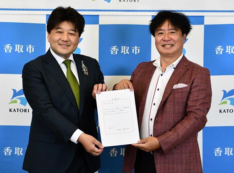 伊藤市長（左）から委嘱状を受け取る花房さん＝香取市役所
