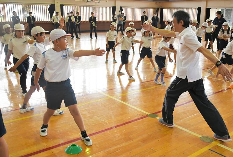 手足を連動させた動きを教える西川さん（手前右）と児童たち＝富里市立富里南小
