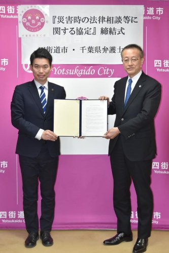 災害時の法律相談等に関する協定を締結した四街道市の鈴木市長（左）と県弁護士会の菊地会長＝同市役所
