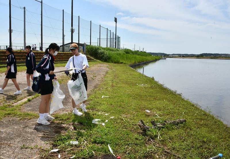黒部川周辺でごみを拾う生徒ら＝２２日、香取市
