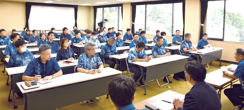 合併７０周年記念事業の一環で、町職員が自ら染めた藍染めシャツで朝礼に参加した＝１日、神崎町役場