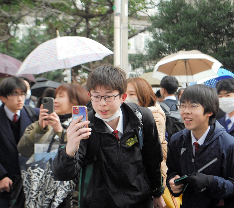 掲示板の受験番号の写真を撮る受験生ら＝３日午前９時１０分ごろ、千葉市中央区の県立千葉高校