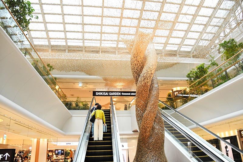成田空港に新登場したシキサイガーデンの４階エントランスで旅客を出迎える竹アート＝７日、成田市