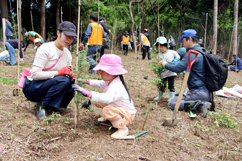 植えた苗木を添え木にくくりつける参加者ら＝９日、山武市
