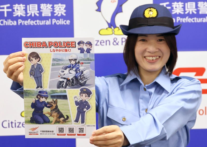 県警の青山本部長がデザインしたクリアファイルを紹介する女性警察官＝２０日、千葉市中央区の県警本部