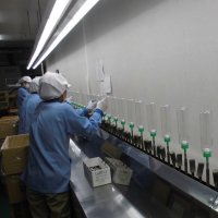容器をラインに設置する従業員
