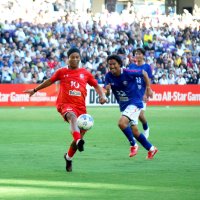 プレーで観客を魅了するロナウジーニョさん（左）と中沢佑二さん（中央）＝２７日、広島市